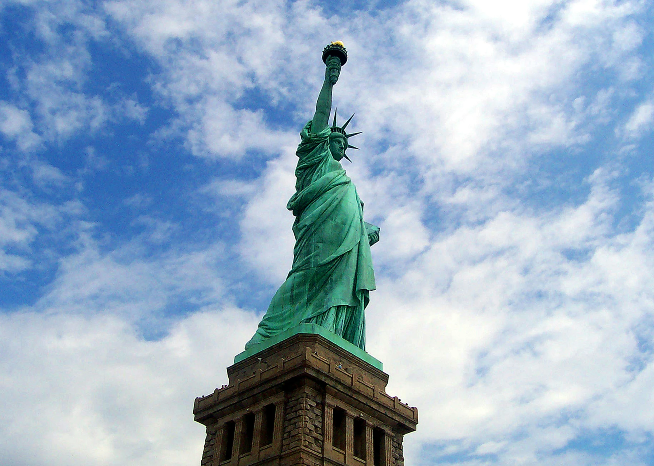 an image of the statue of liberty on a cloudy day