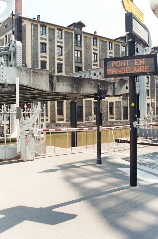 a street sign on the sidewalk with buildings in the background