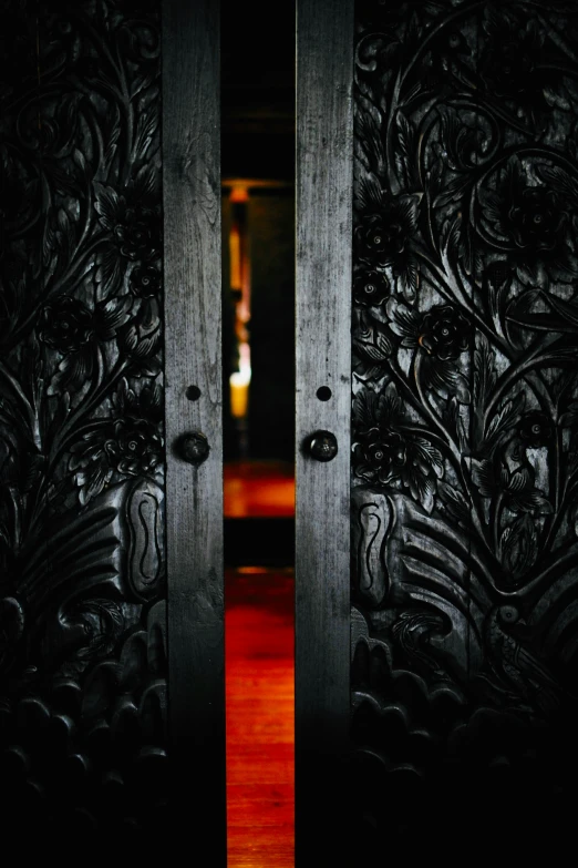 a door is open with wood carvings on it