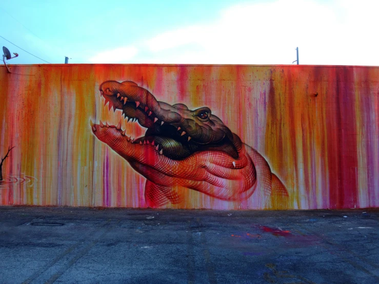 a large painting of a hand holding a large alligator