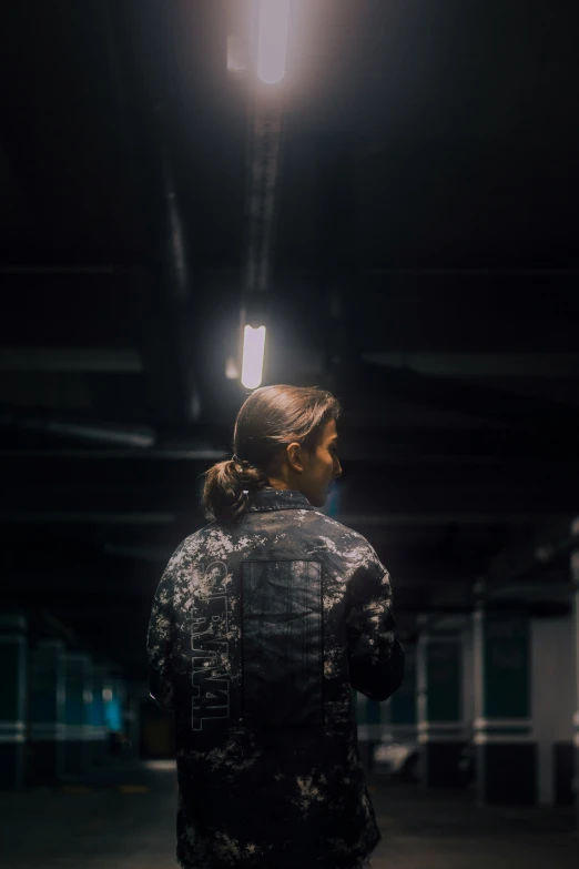 an old woman wearing a black jacket looks at the lights above