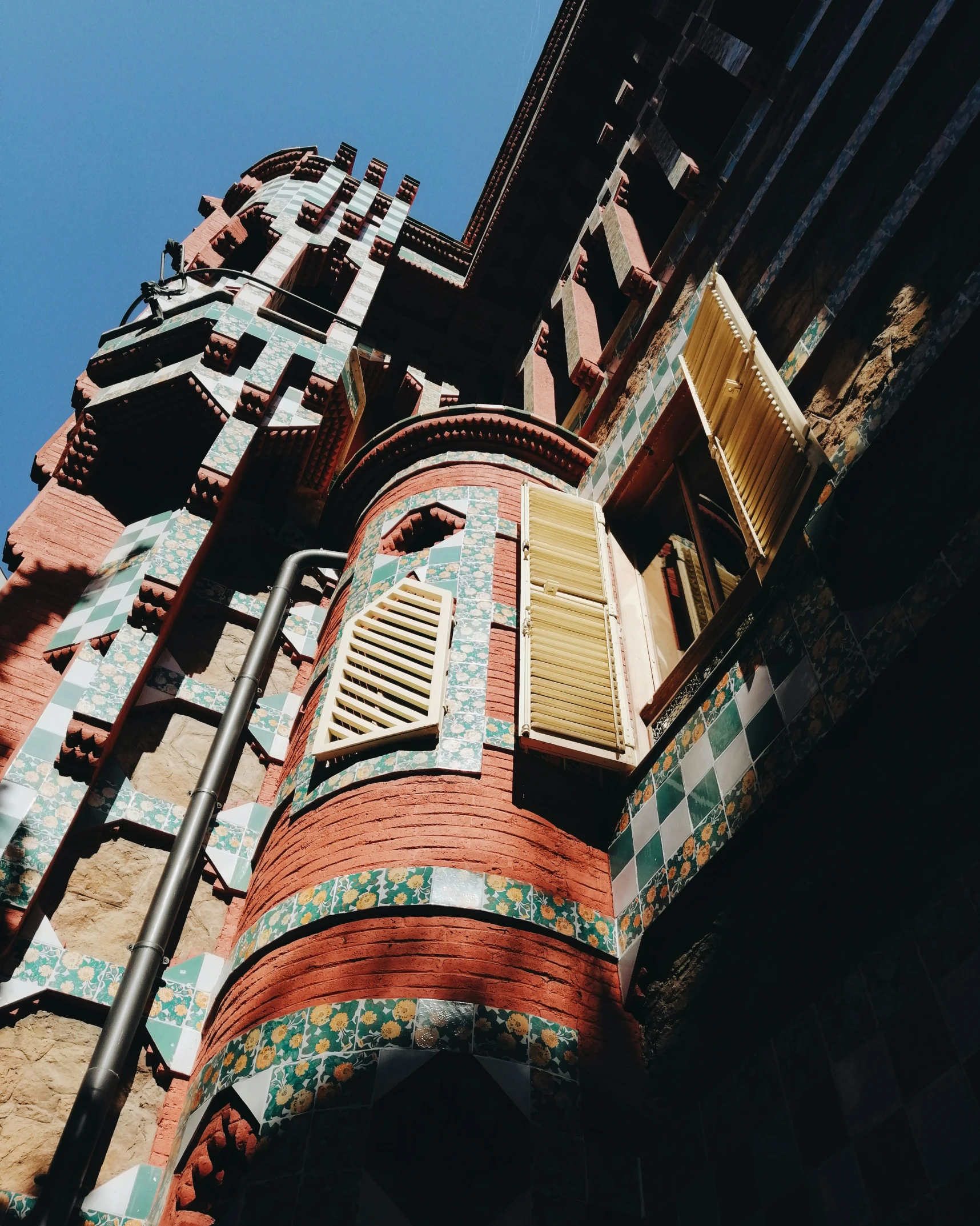 a colorful brick structure with a blue sky background