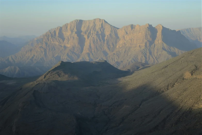 mountains are pictured with the sun shining through them