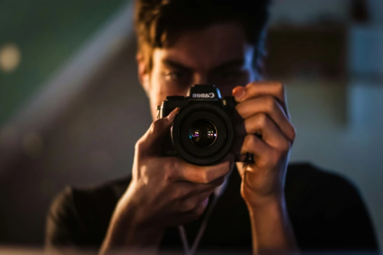 a man holding a camera up to take a picture