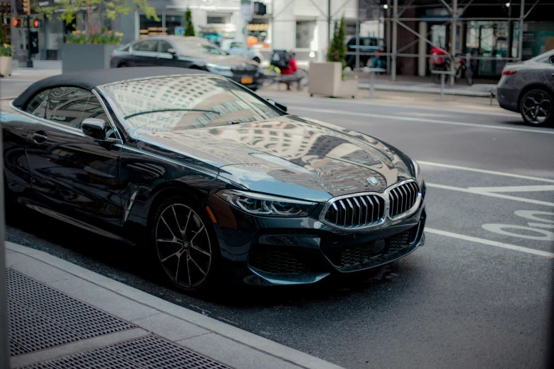 black colored bmw car sitting at the edge of the street