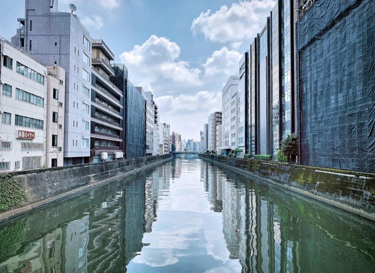 a view of a city street, and buildings on either side, on a clear day