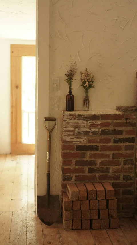 a brick fire place sitting in front of a wall with bricks stacked