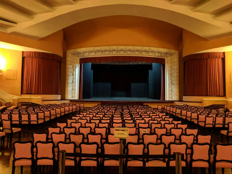 an empty theatre with rows of chairs