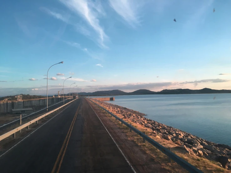 a road near some water and a beach