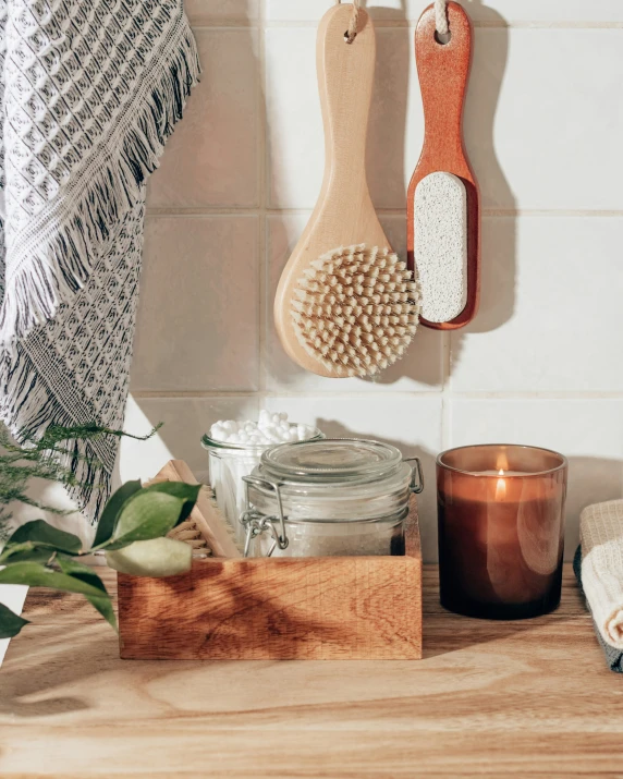 two wooden spoons and two metal scrubbers hanging from the wall