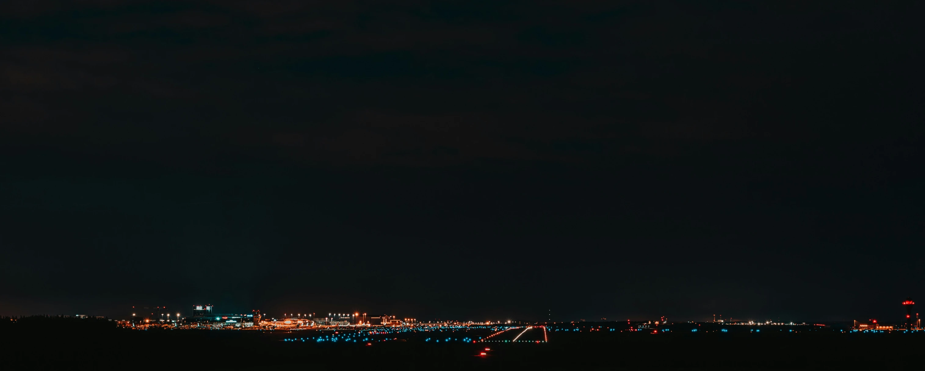 the city in the distance is lit up at night