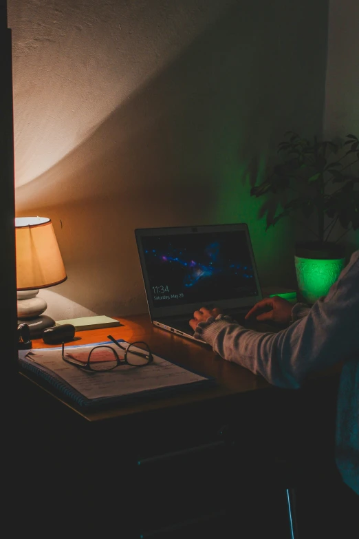 man sitting in front of a laptop in the dark