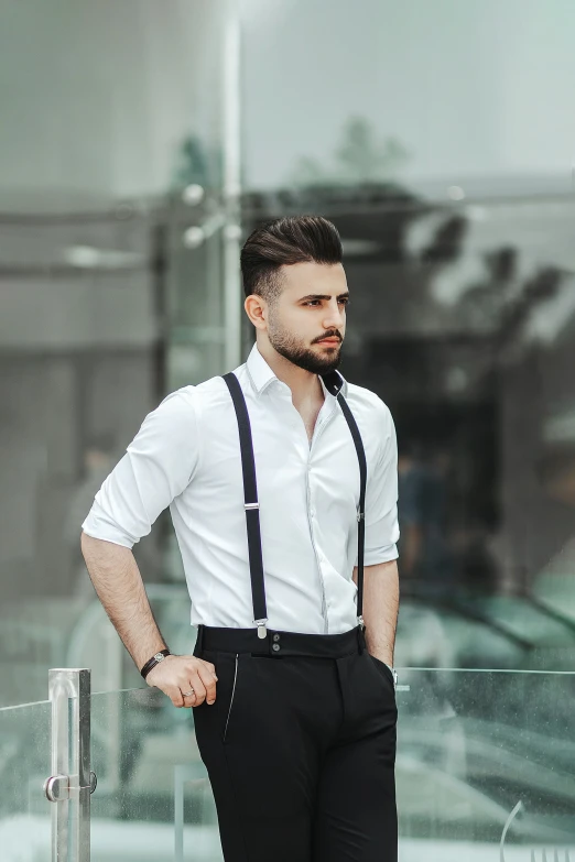 a man is standing wearing a shirt and tie