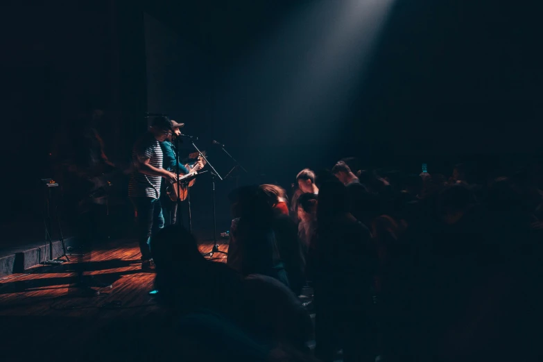 several people at a concert with one singing