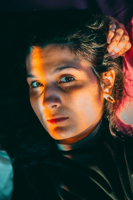 a girl with her hair combed is shown in the shadows