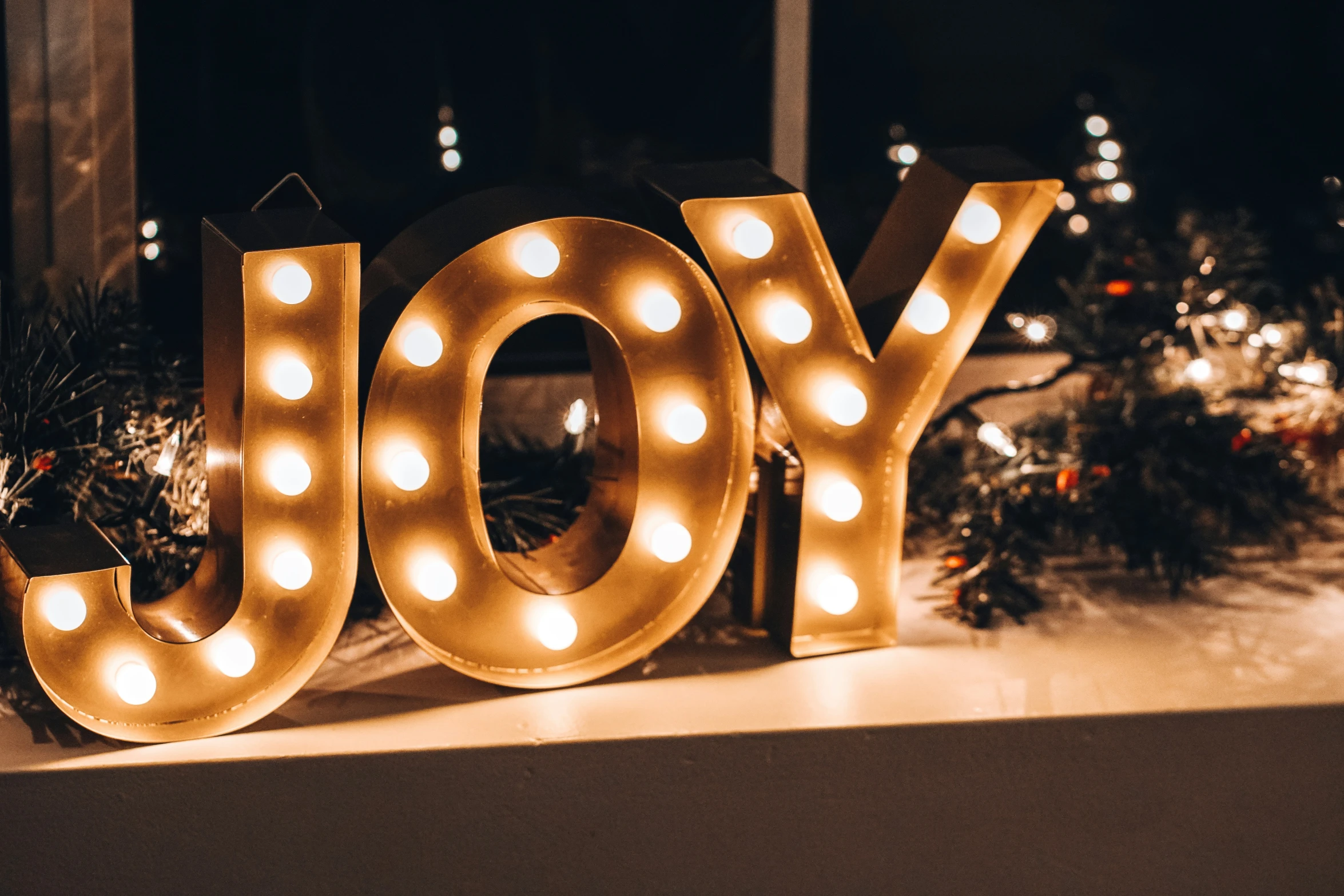 a large light up letter that reads joy