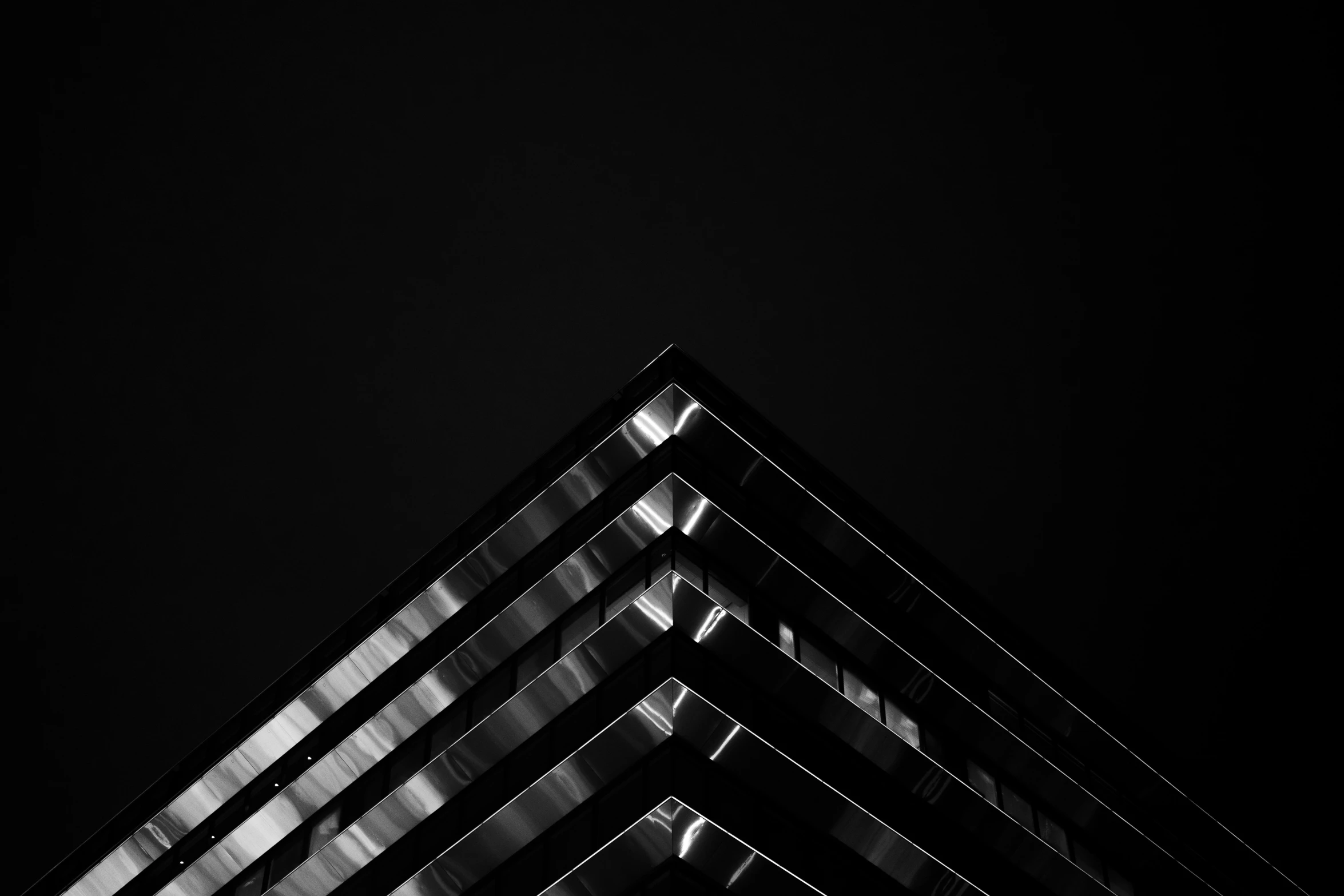 a building's reflection on a dark night sky