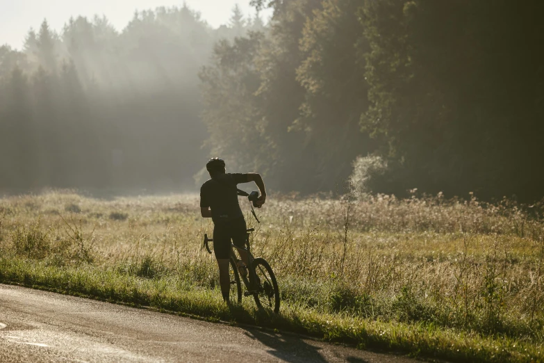 a man rides a bike through a field