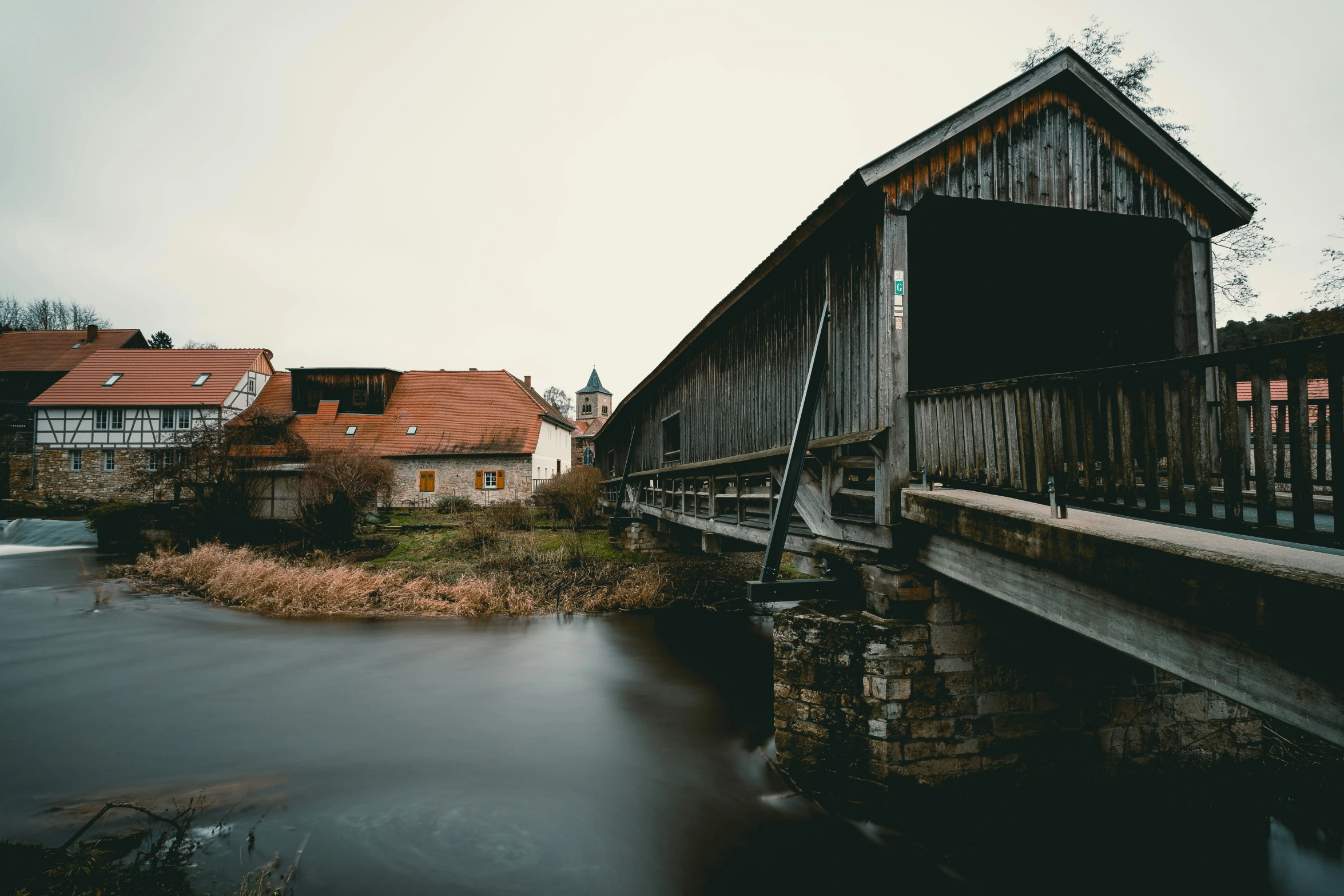 old wooden bridge crossing over a small river