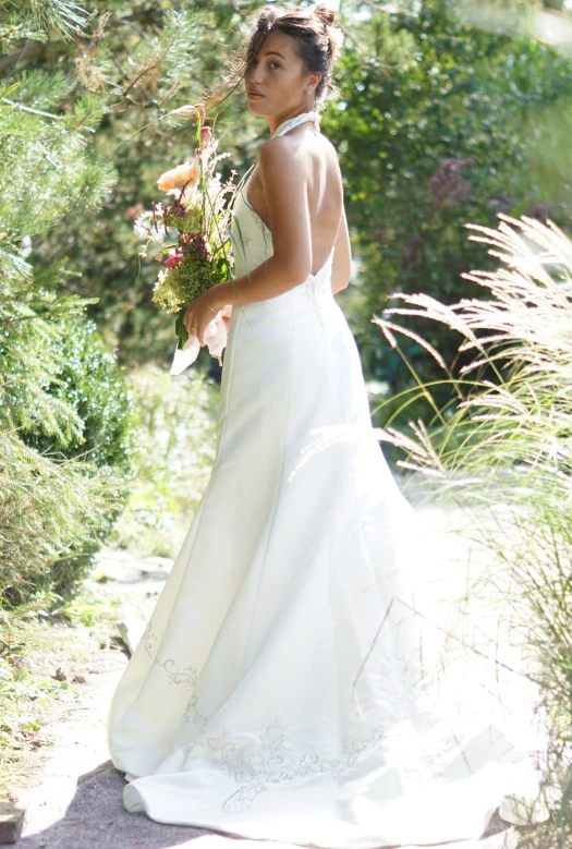 a woman dressed in white poses for a pograph