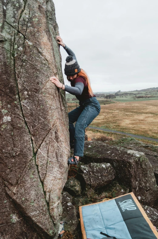 a man is rock climbing up the side of a mountain