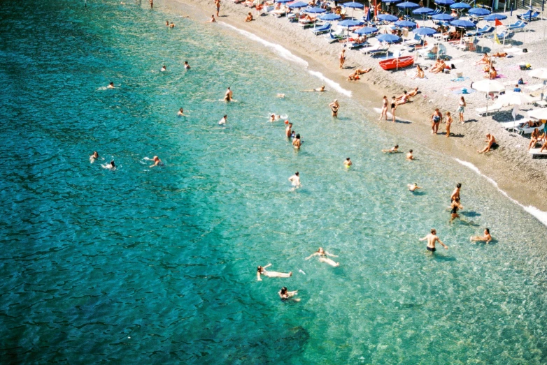 an aerial view of people on a beach near the ocean