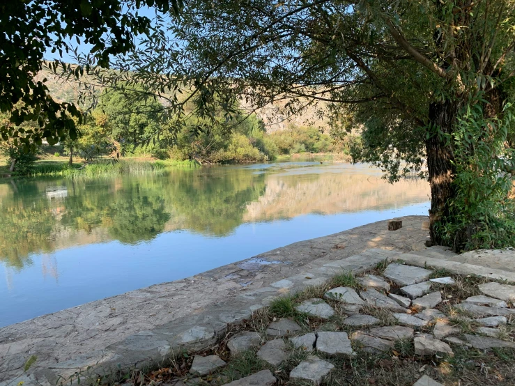 a view of a river with some rocks around it