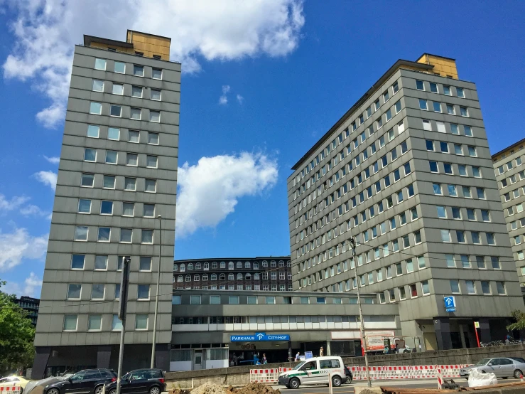 a view of two large gray buildings next to each other