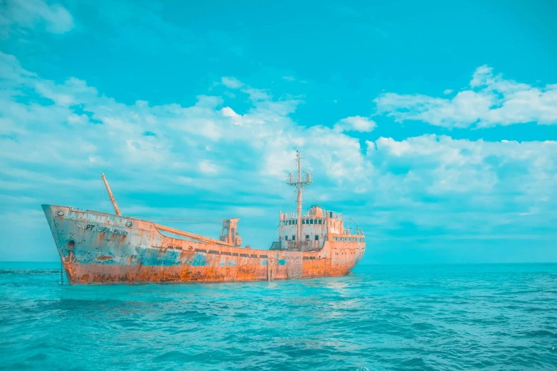 an abandoned wooden boat floating off the ocean