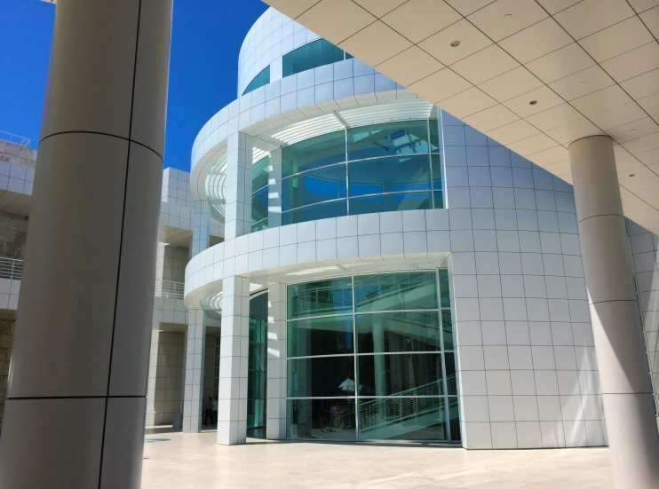 a large white circular building with pillars in front of it