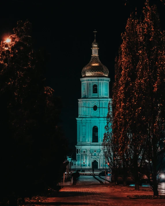 night lights decorate the church tower and surrounding trees