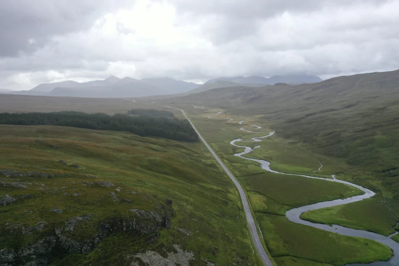 a road winding into the distance in the middle of a valley