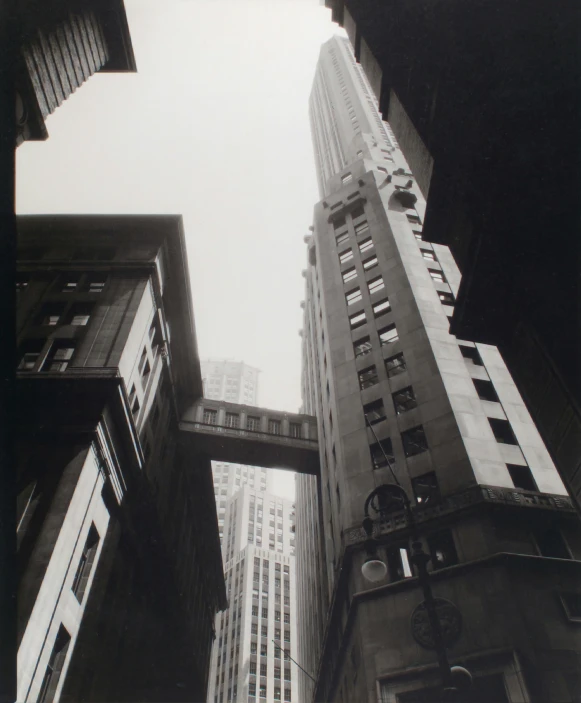 tall buildings line the street, one being over by a bridge