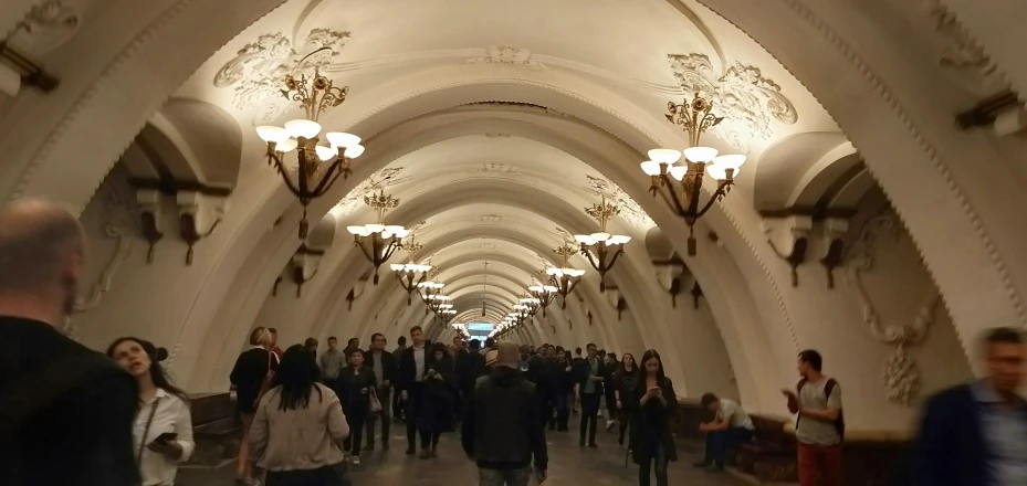 many people are walking in a very large building