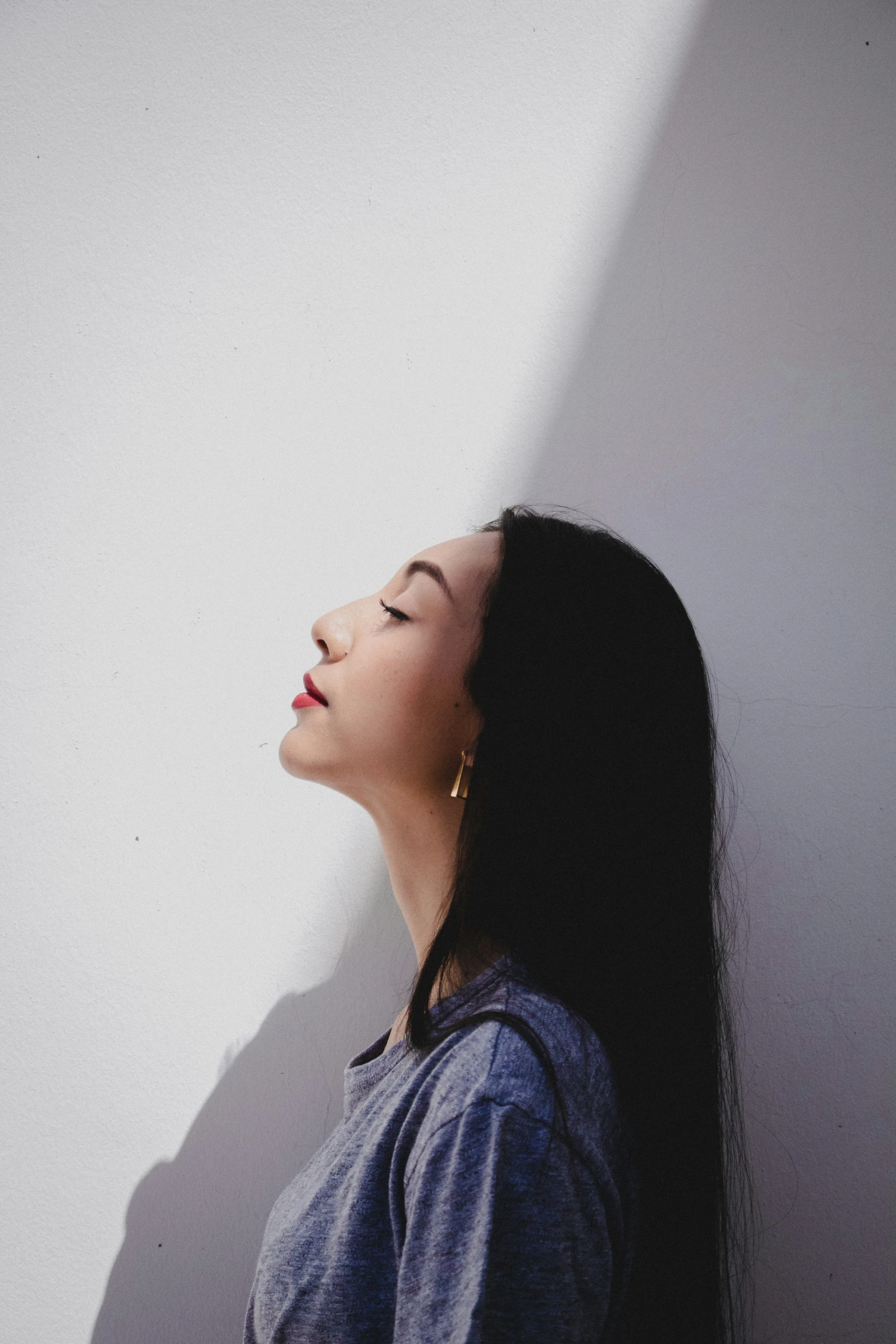 an asian woman in profile in shadow