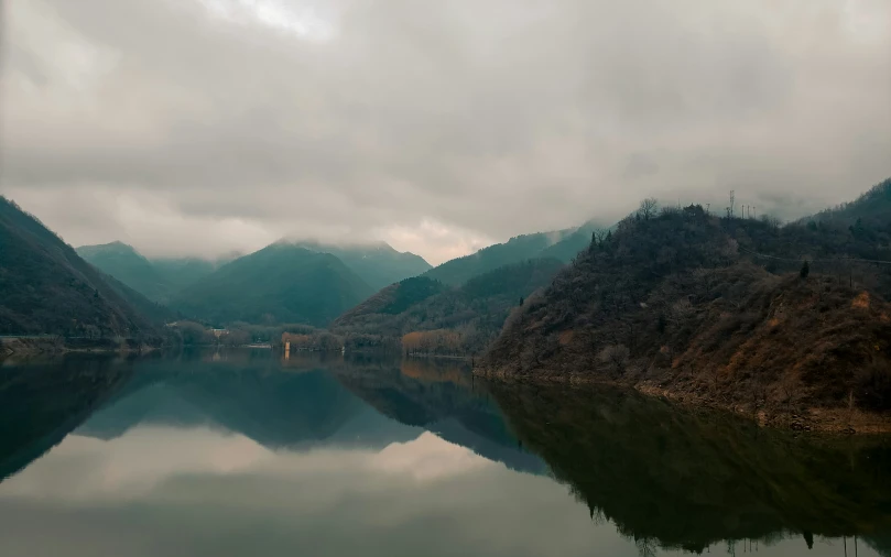 a lake on the side of a mountain range