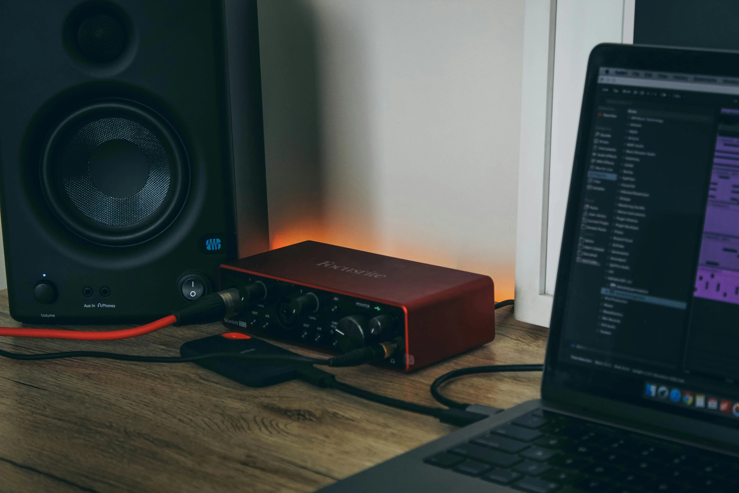 a laptop computer sitting next to a speaker