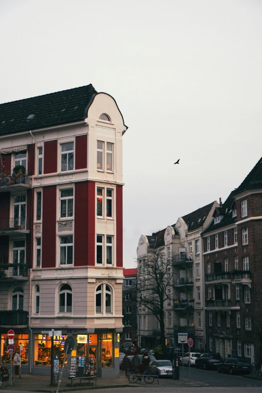 a street view with a tall building in the background