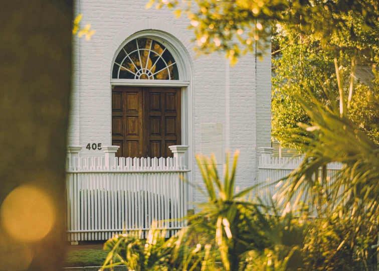 the door is open by the tree outside the church