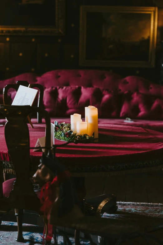 a candle on the table in front of the couch