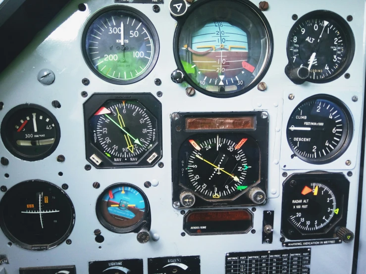 a group of clocks on the side of a plane