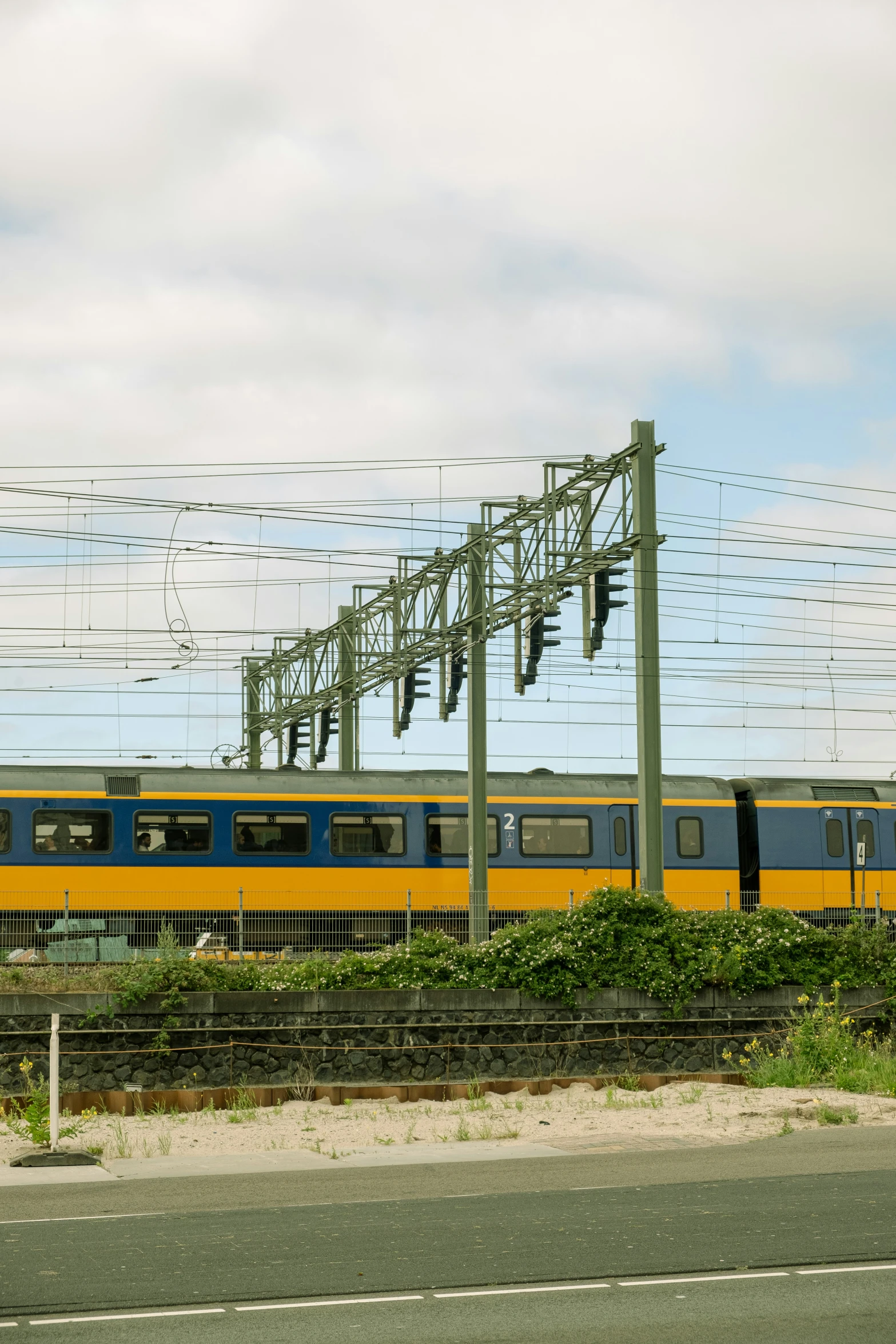 a train traveling down tracks under power lines