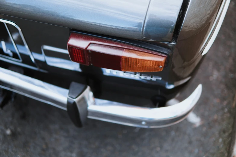 a rear taillight of a car parked in a lot