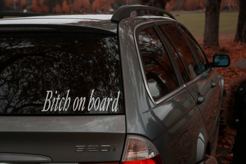 a car that has a sign that says bitch on board