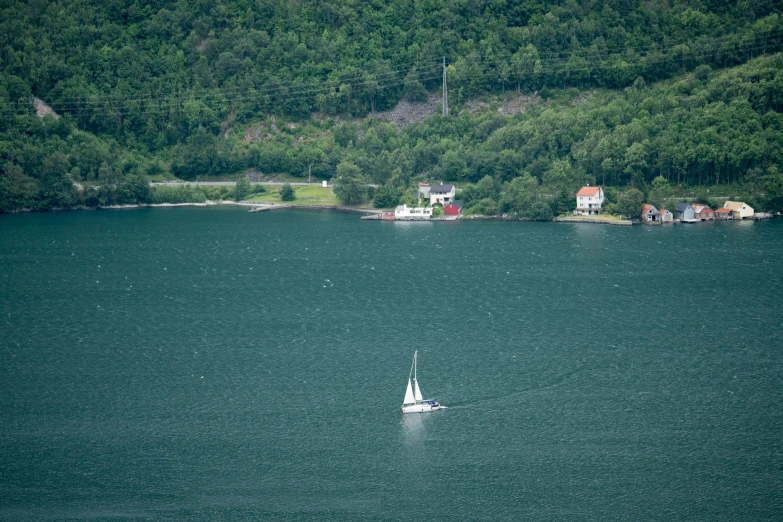 there is a small boat in the large body of water