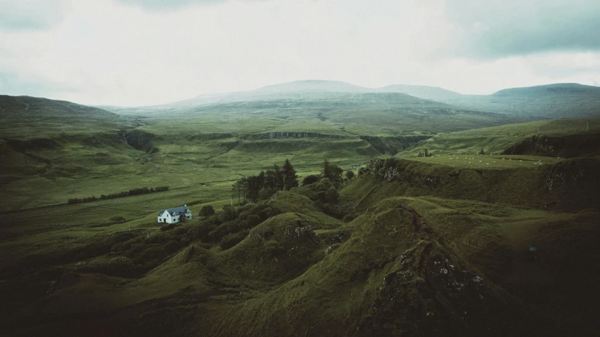 the top half of an open field with hills in the distance