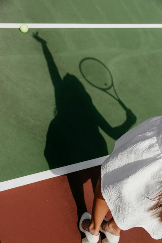 a person holding a tennis racket on a court