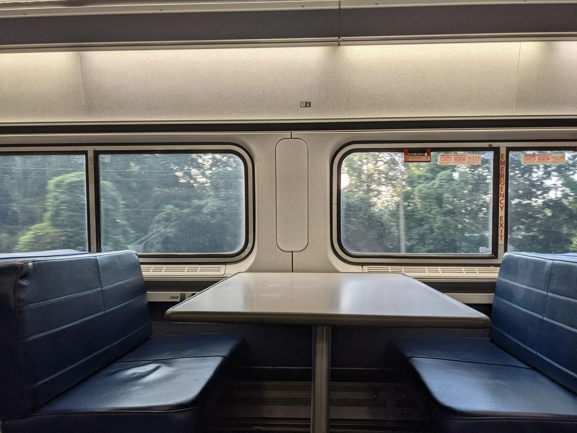 empty benches are arranged on the back of a commuter train