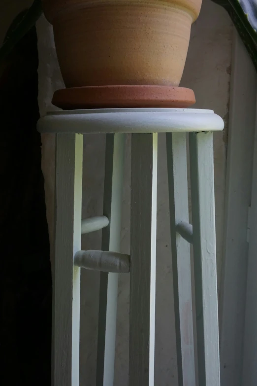 a large potted plant sitting on top of a wooden stand