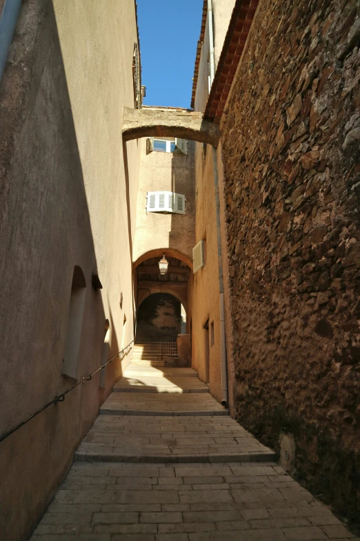 a walkway between two buildings and a gate